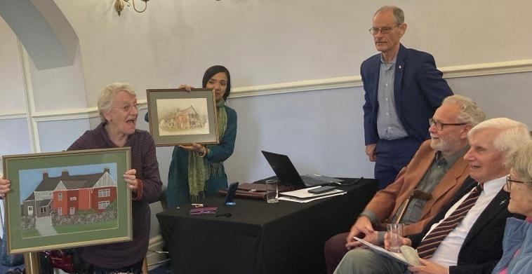 Libbie Sheppard shows pictures of Roughmoor Centre, one painted by Hamish Rosie and the other hand stitched by Ethel Waters